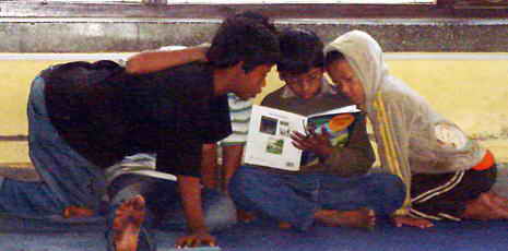 Vier Kinder mit einem Buch.